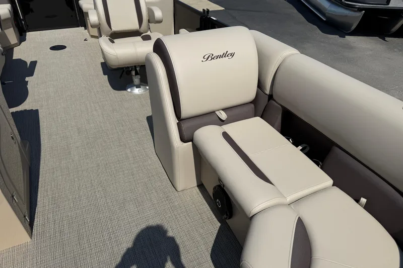 Slide: The Image of 2026 Bentley Pontoons Legacy 200 Navigator interior with beige seating and carpet flooring. - 9