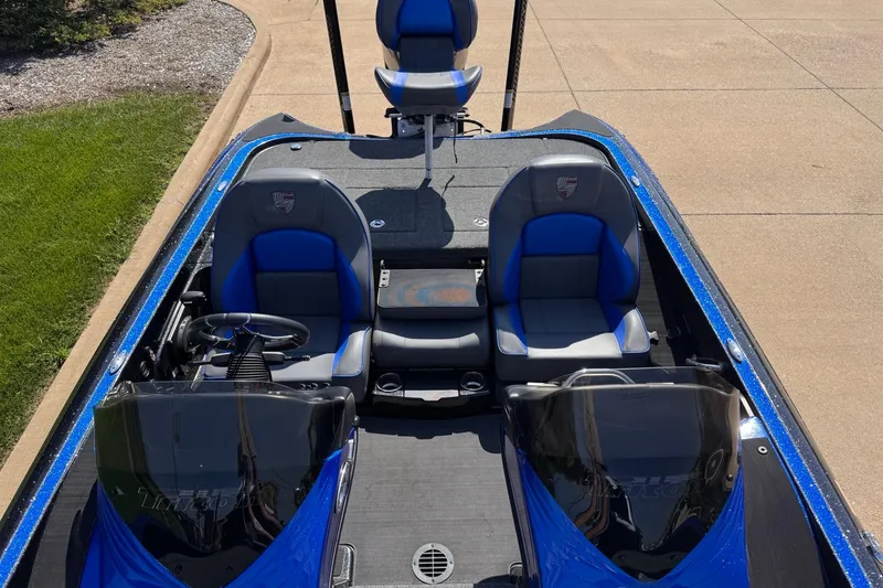 Slide: The Image of 2023 Triton 21TRXP boat interior with blue and gray seating, dual consoles, and steering wheel. - 1