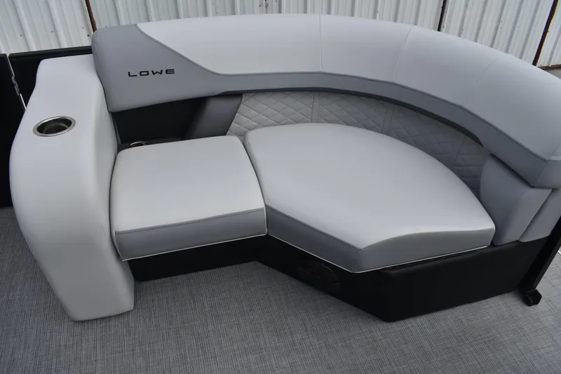 Slide: The Image of Luxurious seating on 2026 Lowe SS 210 boat with quilted upholstery and cup holder. - 16