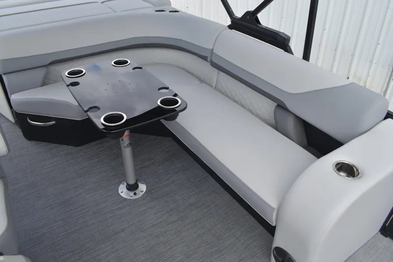 Slide: The Image of 2026 Lowe SS 210 boat interior with gray seating and a table with cup holders. - 17