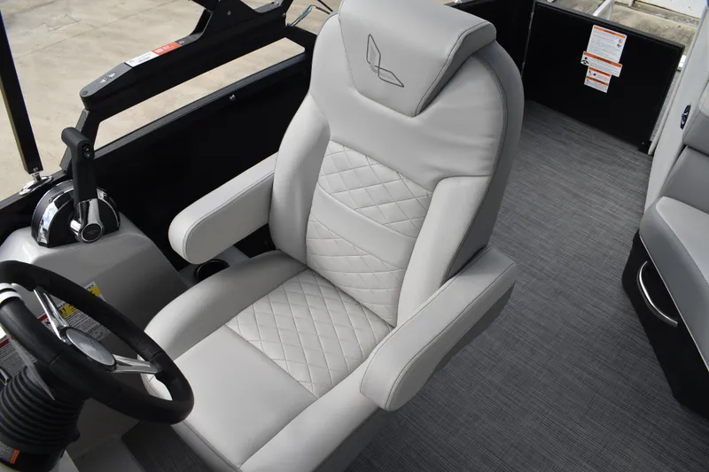 Slide: The Image of 2026 Lowe SS 210 boat interior with luxurious gray captain's chair and steering wheel. - 20