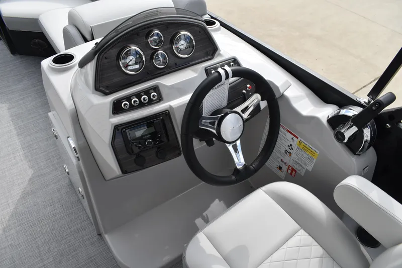 Slide: The Image of 2026 Lowe SS 210 boat dashboard with steering wheel and control panel. - 22