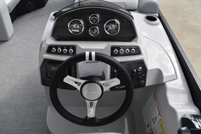 Slide: The Image of 2026 Lowe SS 210 boat dashboard with steering wheel and instrument panel. - 24