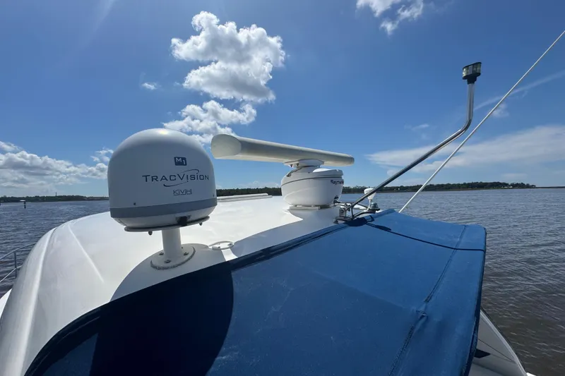 Slide: The Image of 2010 Sea Ray 390 Sundancer with TracVision and Raymarine equipment on a sunny day. - 10