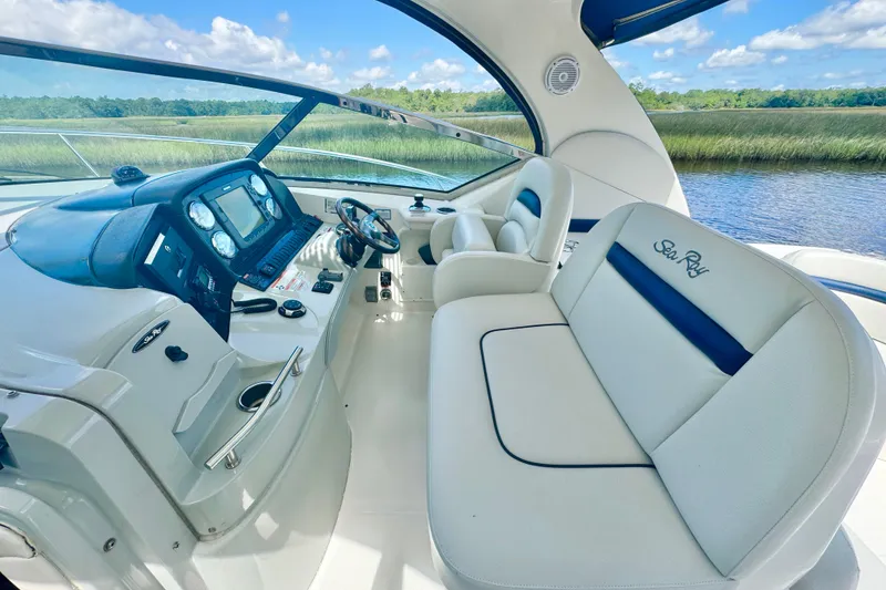 Slide: The Image of 2010 Sea Ray 390 Sundancer cockpit with luxurious seating and modern controls. - 12