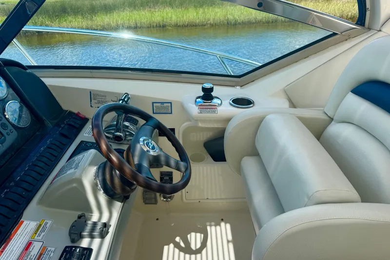 Slide: The Image of Helm of 2010 Sea Ray 390 Sundancer with leather seating and wooden steering wheel. - 15
