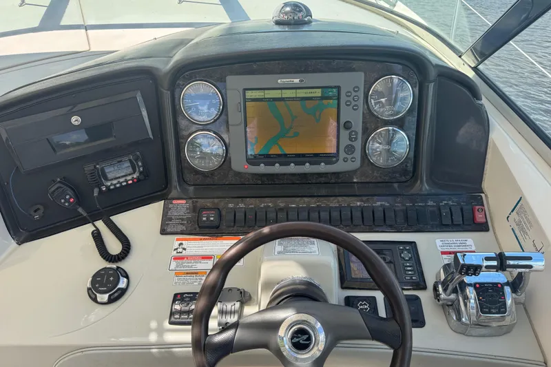 Slide: The Image of Helm of 2010 Sea Ray 390 Sundancer with navigation system and controls. - 19
