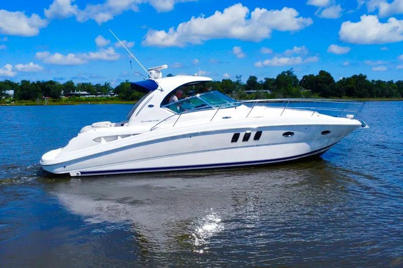 Slide: The Image of 2010 Sea Ray 390 Sundancer yacht cruising on a sunny day with blue skies. - 2
