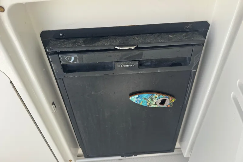 Slide: The Image of Dometic refrigerator on 2010 Sea Ray 390 Sundancer boat, featuring a colorful handle. - 23