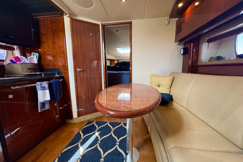 Slide: The Image of Luxurious interior of 2010 Sea Ray 390 Sundancer yacht with elegant seating and wooden finishes. - 25