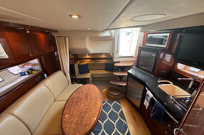 Slide: The Image of Luxurious interior of 2010 Sea Ray 390 Sundancer yacht with modern kitchen and seating area. - 26