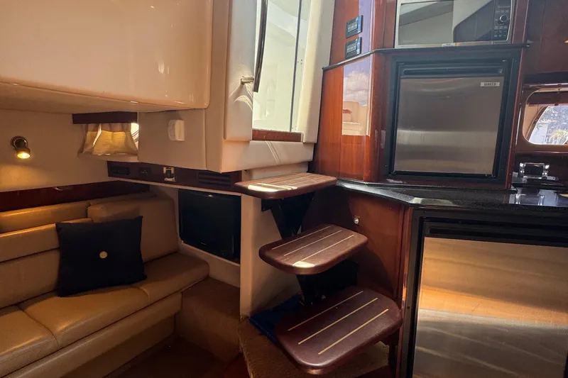 Slide: The Image of Interior of 2010 Sea Ray 390 Sundancer yacht with seating, stairs, and kitchenette. - 29