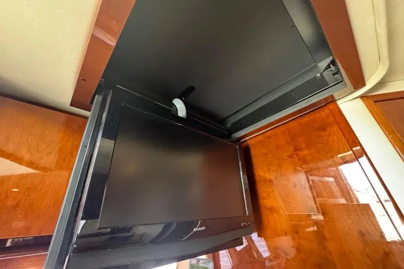 Slide: The Image of Flat-screen TV in 2010 Sea Ray 390 Sundancer yacht interior, mounted on wooden paneling. - 30
