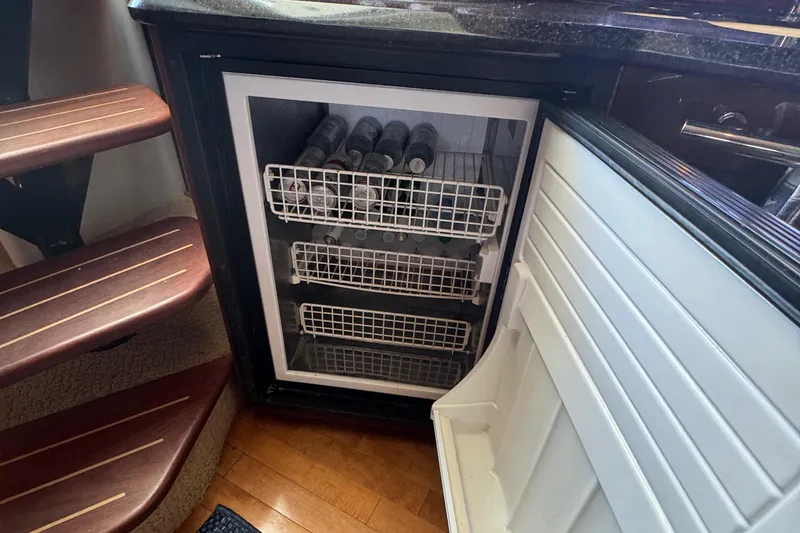 Slide: The Image of Open fridge with beverages inside a 2010 Sea Ray 390 Sundancer yacht interior. - 31