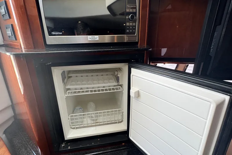Slide: The Image of Open mini fridge and microwave in 2010 Sea Ray 390 Sundancer yacht kitchen. - 33