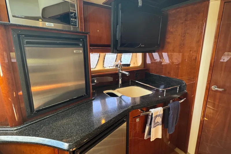 Slide: The Image of Luxurious 2010 Sea Ray 390 Sundancer yacht kitchen with modern appliances and sleek design. - 34