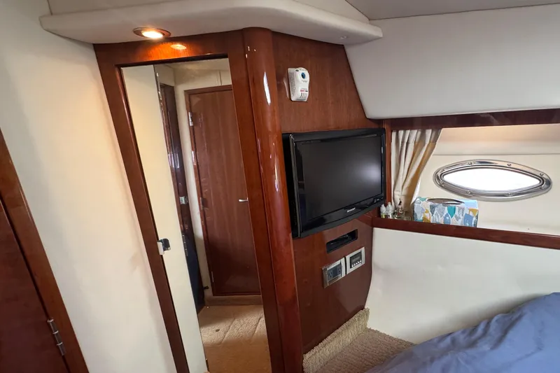 Slide: The Image of Interior of 2010 Sea Ray 390 Sundancer with TV, porthole, and wooden finishes. - 36