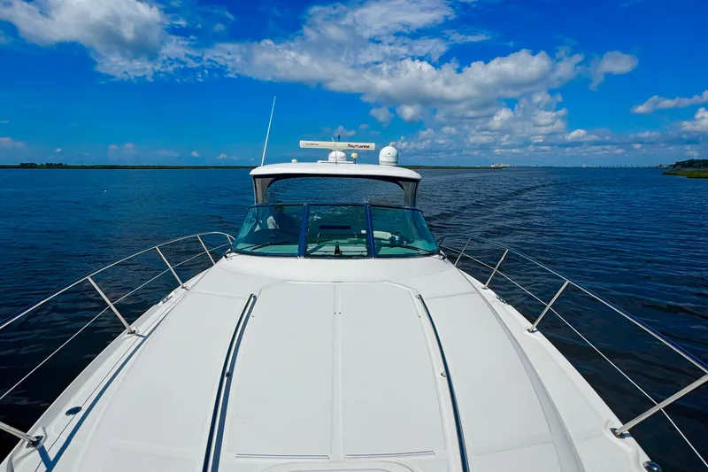 Slide: The Image of Sea Ray 390 Sundancer 2010 cruising on open water under a clear blue sky. - 4