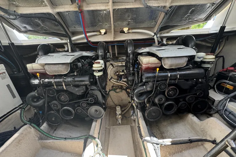 Slide: The Image of Engine compartment of 2010 Sea Ray 390 Sundancer, showcasing dual engines and mechanical components. - 42