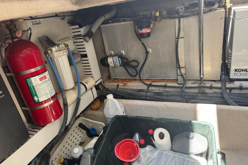 Slide: The Image of Engine room of 2010 Sea Ray 390 Sundancer with fire extinguisher and maintenance supplies. - 48