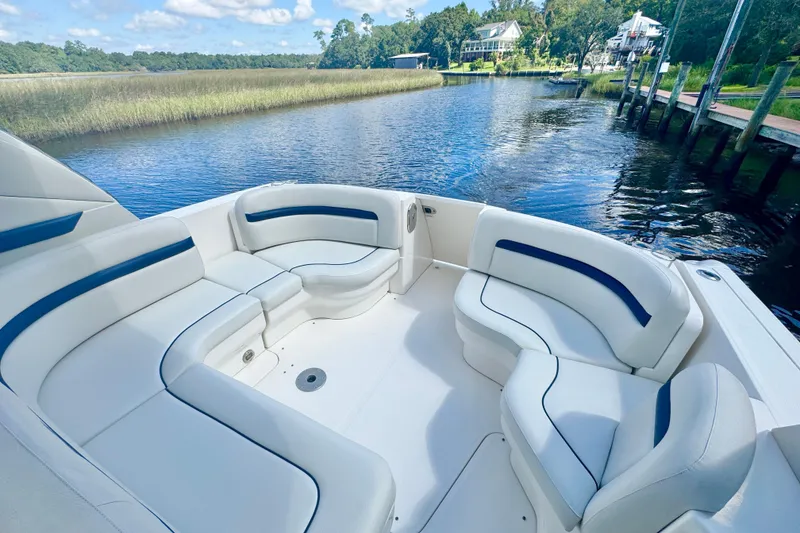Slide: The Image of 2010 Sea Ray 390 Sundancer boat with spacious seating on a serene waterway. - 7