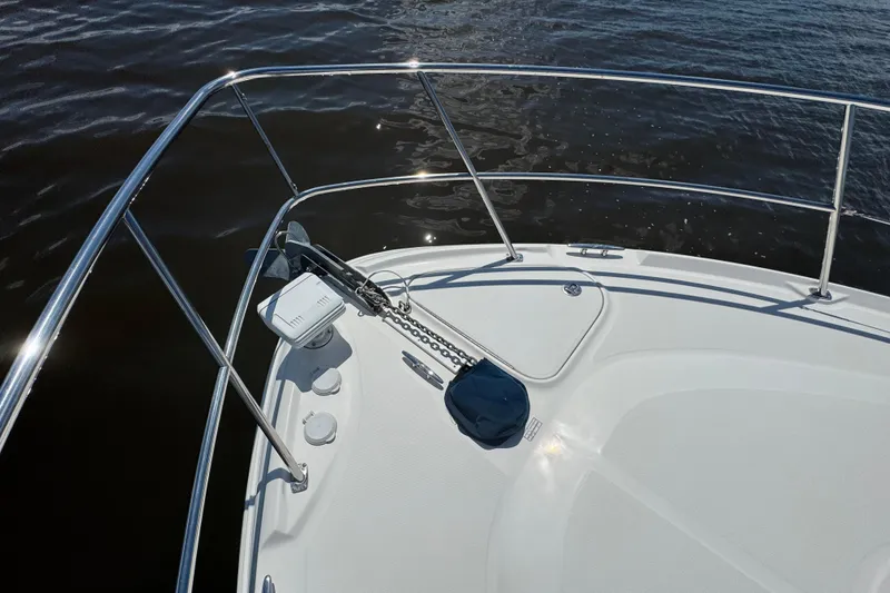 Slide: The Image of Bow of 2010 Sea Ray 390 Sundancer with anchor and railing on calm water. - 9