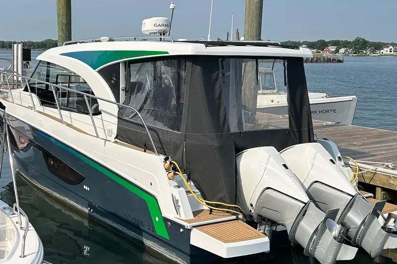 Slide: The Image of 2022 Beneteau Antares 11 docked, featuring dual outboard engines and sleek design. - 1