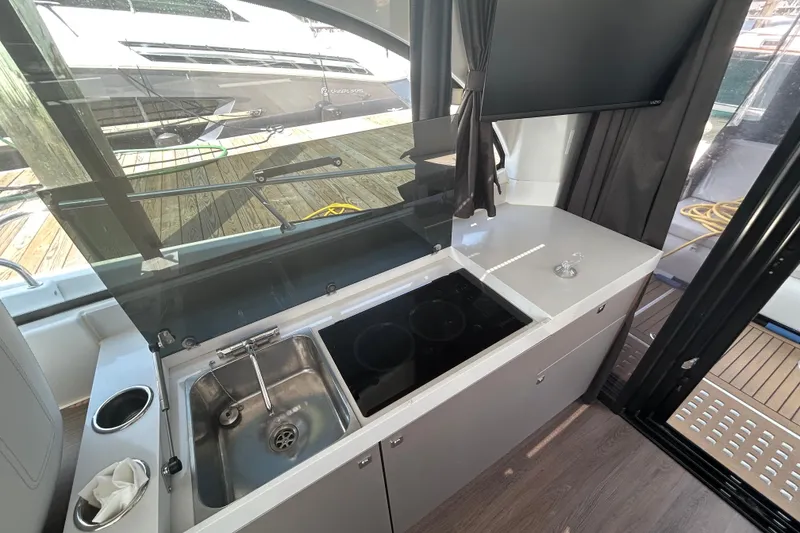 Slide: The Image of Modern kitchen area on 2022 Beneteau Antares 11 yacht with sink and stove. - 10