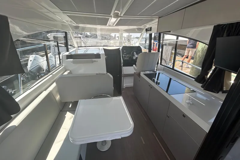 Slide: The Image of Interior of 2022 Beneteau Antares 11, featuring modern seating, table, and helm station. - 11