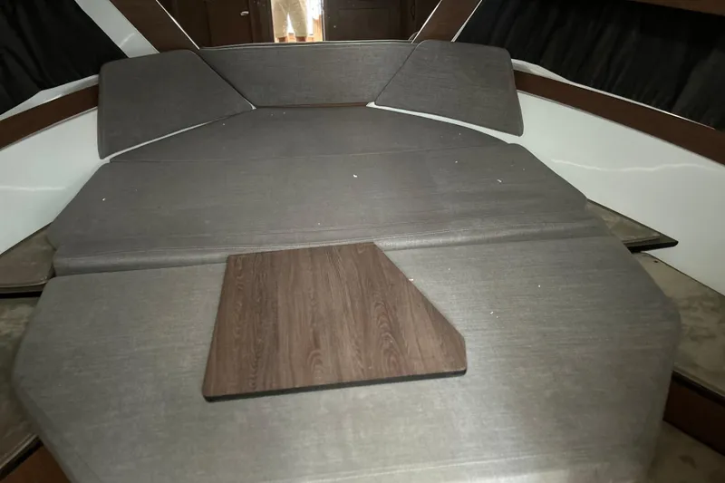 Slide: The Image of Interior cabin of 2022 Beneteau Antares 11 with cushioned seating and wooden table. - 14