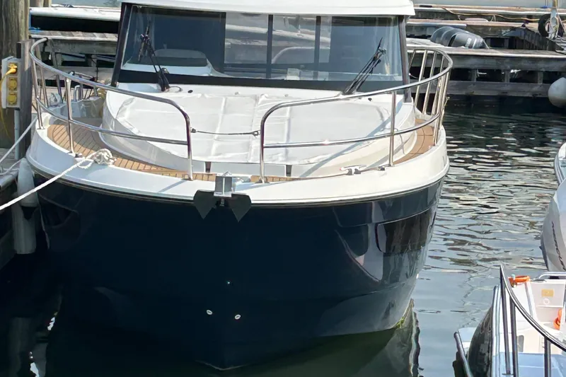 Slide: The Image of 2022 Beneteau Antares 11 docked at marina, front view. - 2