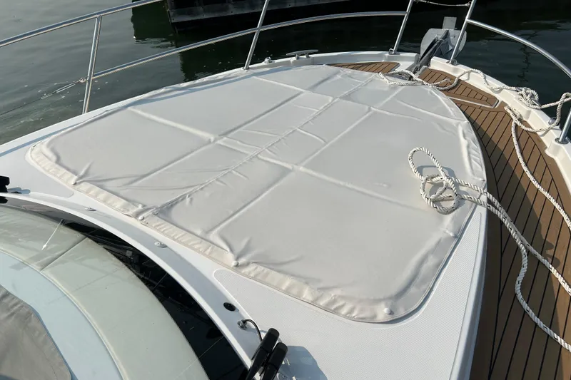Slide: The Image of 2022 Beneteau Antares 11 boat deck with sunpad and teak flooring. - 6