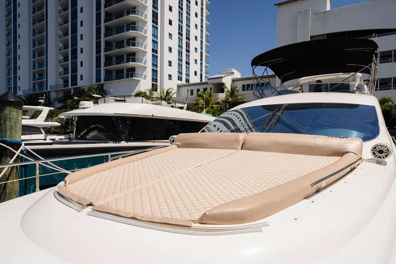 Slide: The Image of Luxury 2006 Aicon Flybridge yacht docked near modern high-rise buildings. - 16