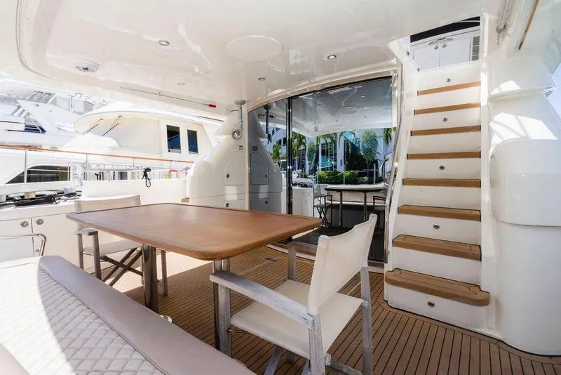 Slide: The Image of Luxurious 2006 Aicon Flybridge yacht interior with elegant dining area and wooden staircase. - 25