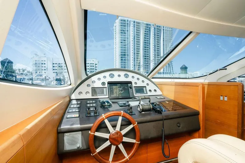 Slide: The Image of Interior view of 2006 Aicon Flybridge yacht cockpit with cityscape background. - 31