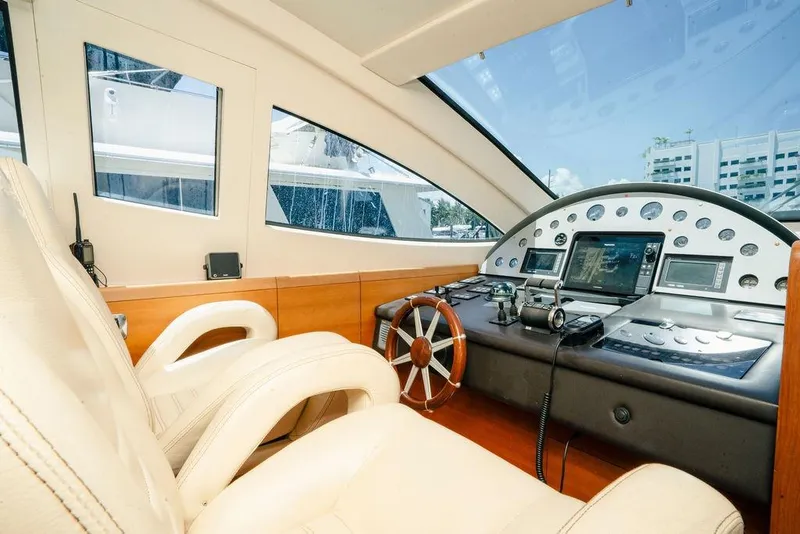 Slide: The Image of Luxurious 2006 Aicon Flybridge yacht cockpit with modern navigation instruments and leather seating. - 32