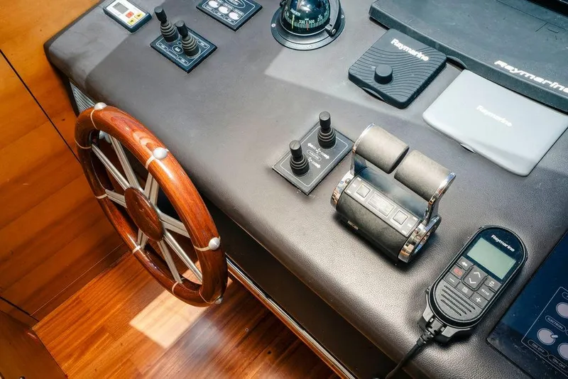Slide: The Image of Control panel of 2006 Aicon Flybridge yacht with wooden steering wheel and navigation equipment. - 34