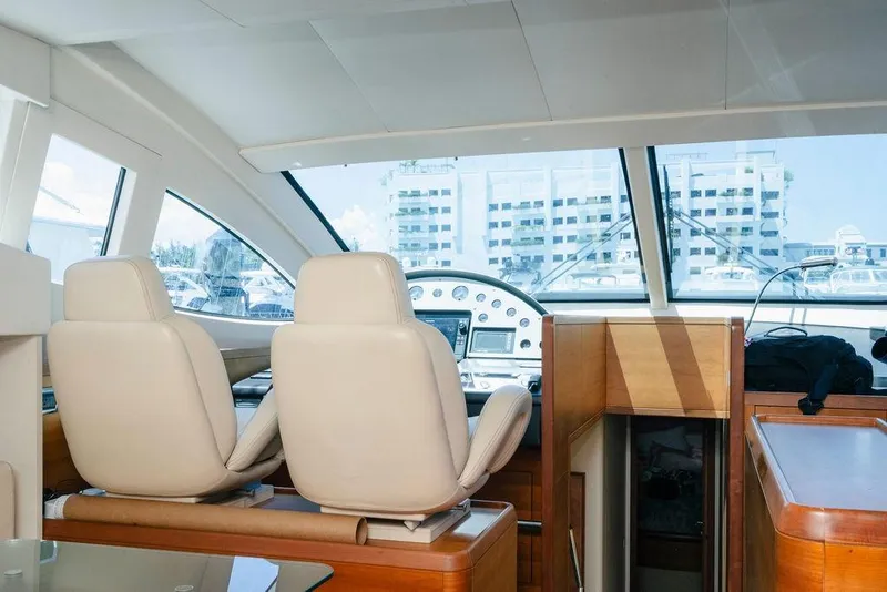 Slide: The Image of Interior view of 2006 Aicon Flybridge yacht cockpit with modern controls and seating. - 37