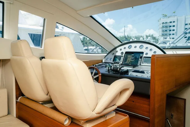 Slide: The Image of Interior of 2006 Aicon Flybridge yacht with leather seats and modern control panel. - 38