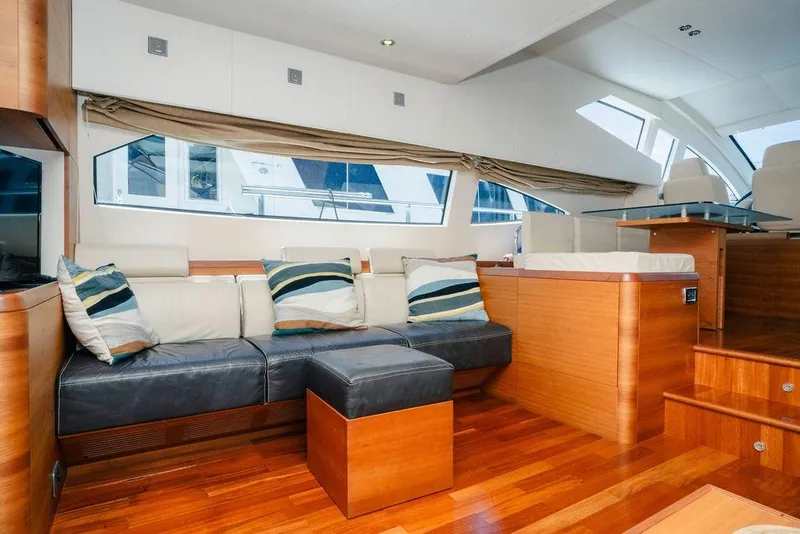 Slide: The Image of Luxurious 2006 Aicon Flybridge yacht interior with modern seating and elegant wood finishes. - 55