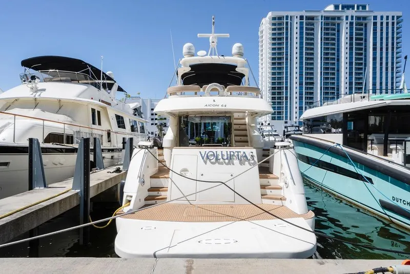 Slide: The Image of Luxury 2006 Aicon Flybridge yacht docked at marina with modern buildings in background. - 6