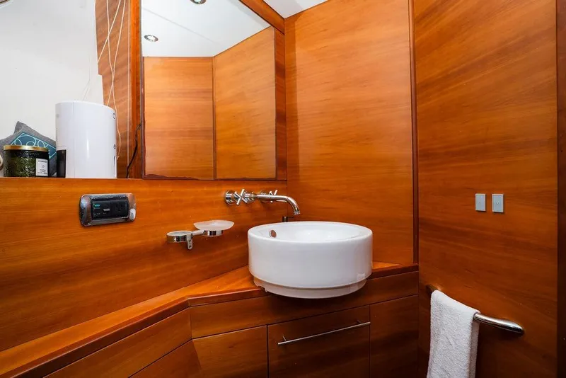 Slide: The Image of Luxurious wooden bathroom interior on 2006 Aicon Flybridge yacht, featuring modern sink and fixtures. - 62