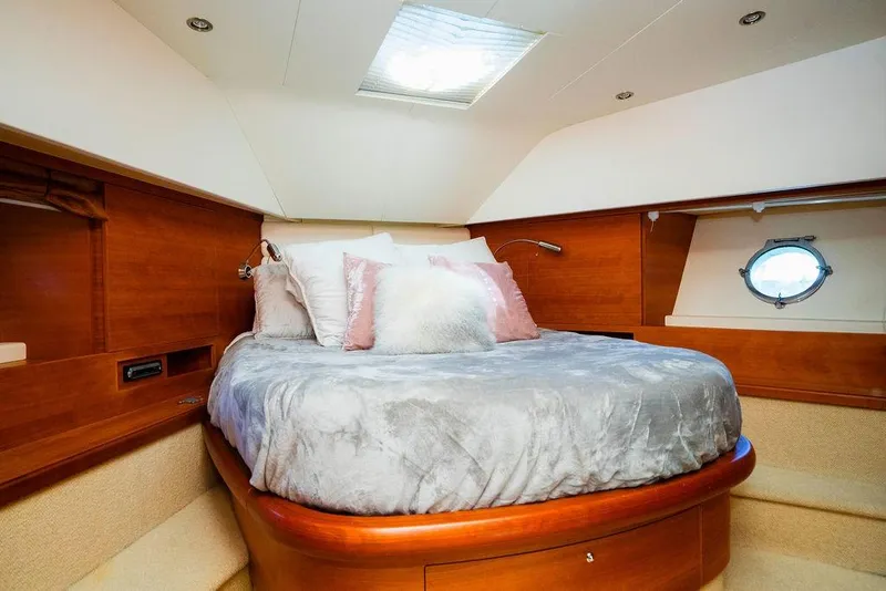 Slide: The Image of Luxurious 2006 Aicon Flybridge yacht bedroom with cozy bedding and elegant wood finish. - 73
