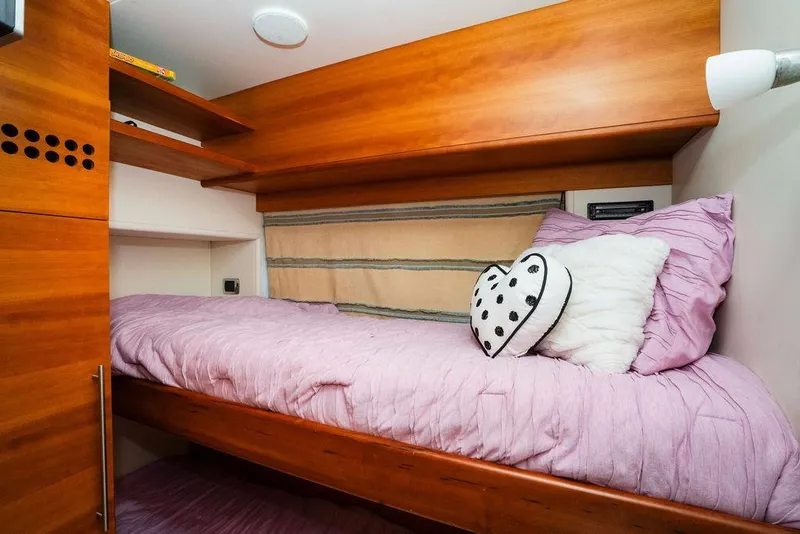 Slide: The Image of Cozy cabin bed in 2006 Aicon Flybridge yacht with pink bedding and heart pillow. - 83
