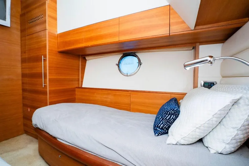 Slide: The Image of Luxurious 2006 Aicon Flybridge yacht cabin with wooden interior and cozy bedding. - 85