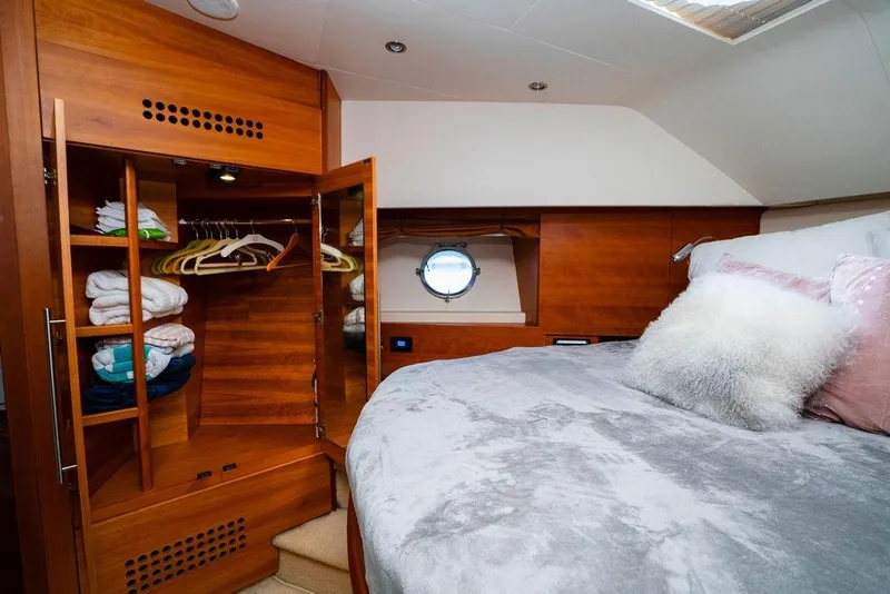 Slide: The Image of Luxurious 2006 Aicon Flybridge yacht bedroom with wooden wardrobe and cozy bedding. - 93