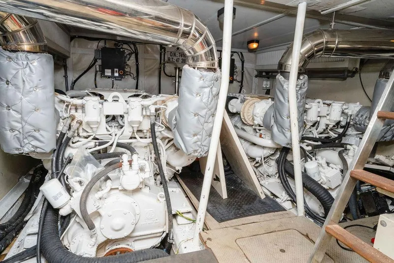 Slide: The Image of Engine room of 2006 Aicon Flybridge yacht, featuring dual engines and exhaust systems. - 95