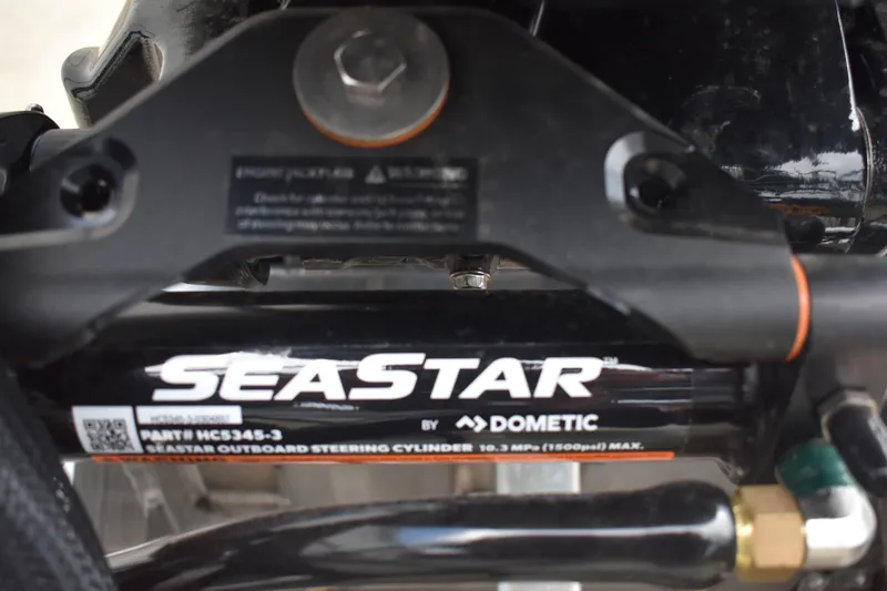 Slide: The Image of Open storage compartment in 2026 Lowe LF 232 boat seat, gray upholstery. - 10