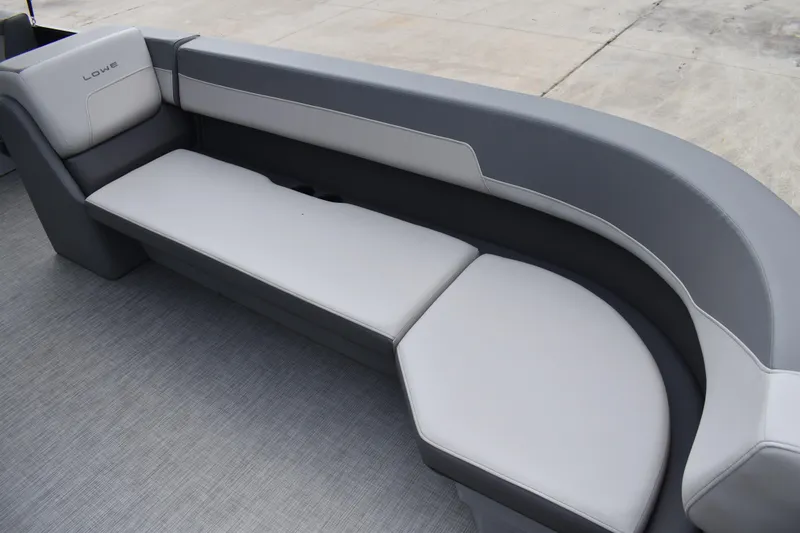 Slide: The Image of 2026 Lowe LF 232 boat storage compartment with cup holders and black cover. - 23