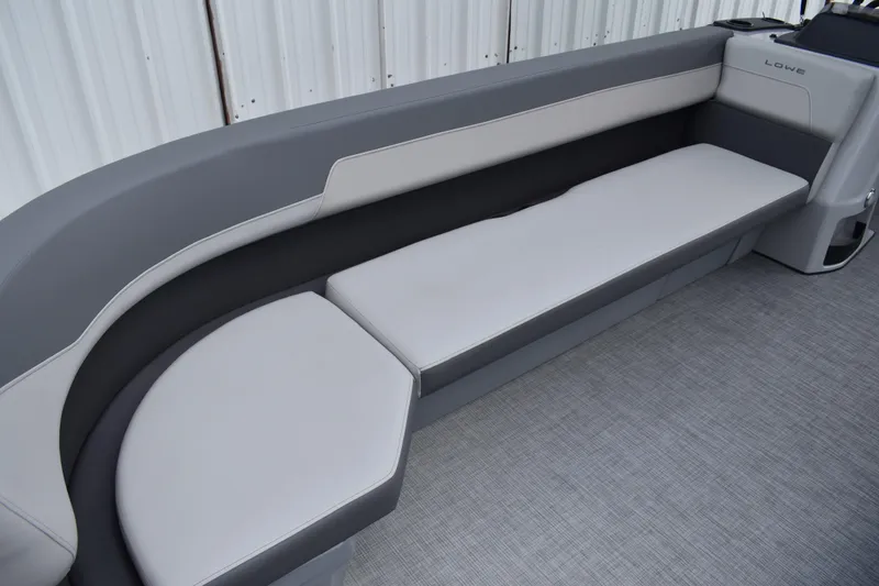 Slide: The Image of 2026 Lowe LF 232 boat dashboard with steering wheel and control panel. - 24